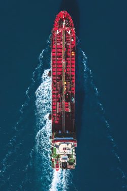 Aerial view of oil tanker ship. Industrial ship on the move. Environmental issues and climate change